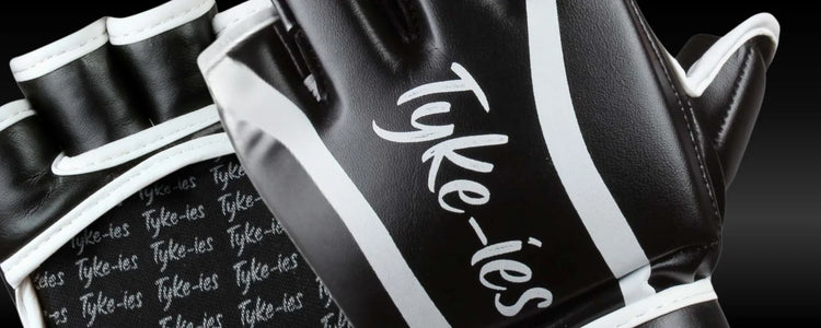 Close-up of Tyke-ies MMA gloves showing the open-palm design and metacarpal protection for grappling and striking.