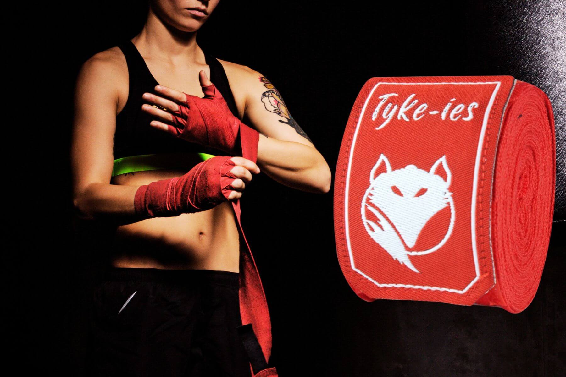 Tyke-ies hand wraps collection showcasing various types, including traditional  hand wraps and glove hand wraps in black and red, perfect for boxing, kickboxing and MMA training.